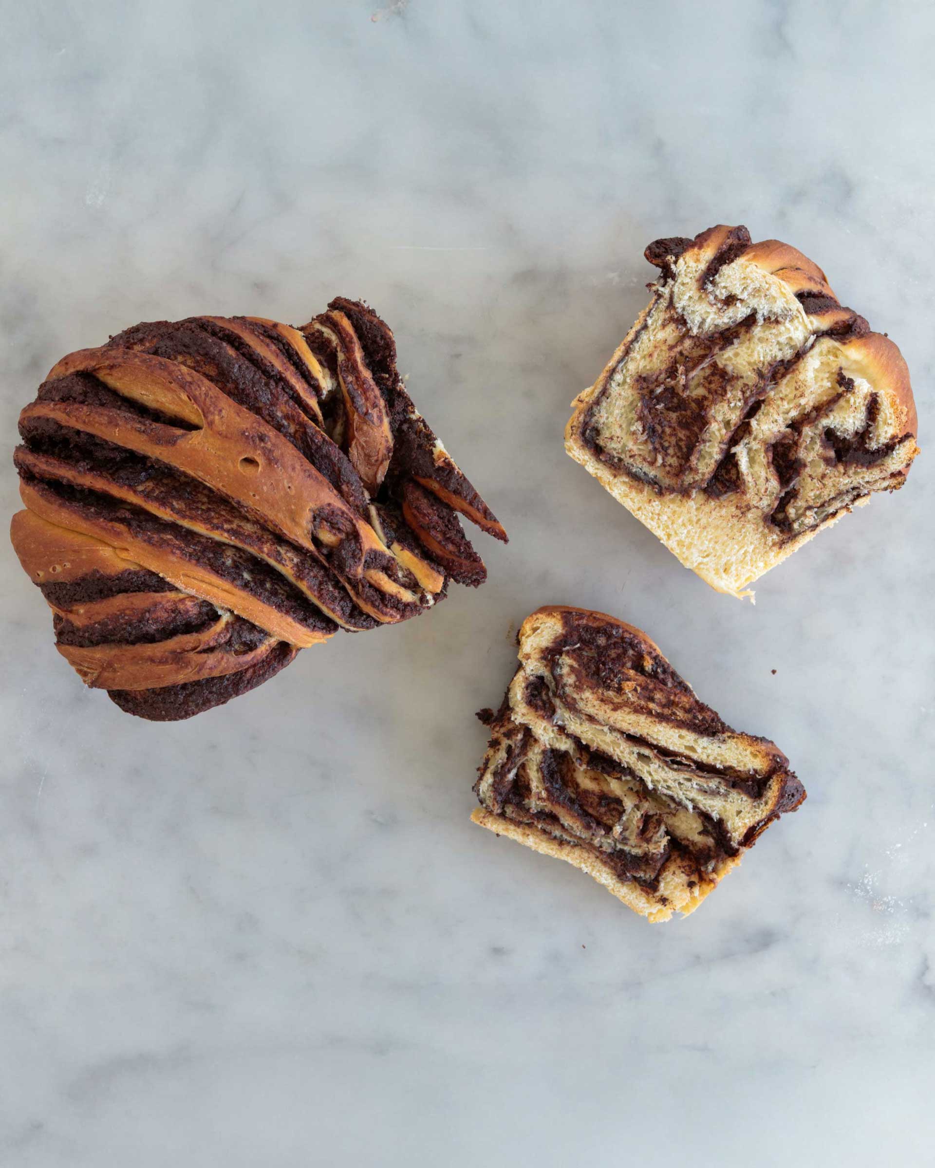 Baked chocolate babka, sliced to show the chocolate swirl