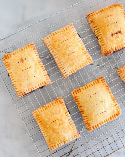 Baked pastry tarts cooling on a wire rack