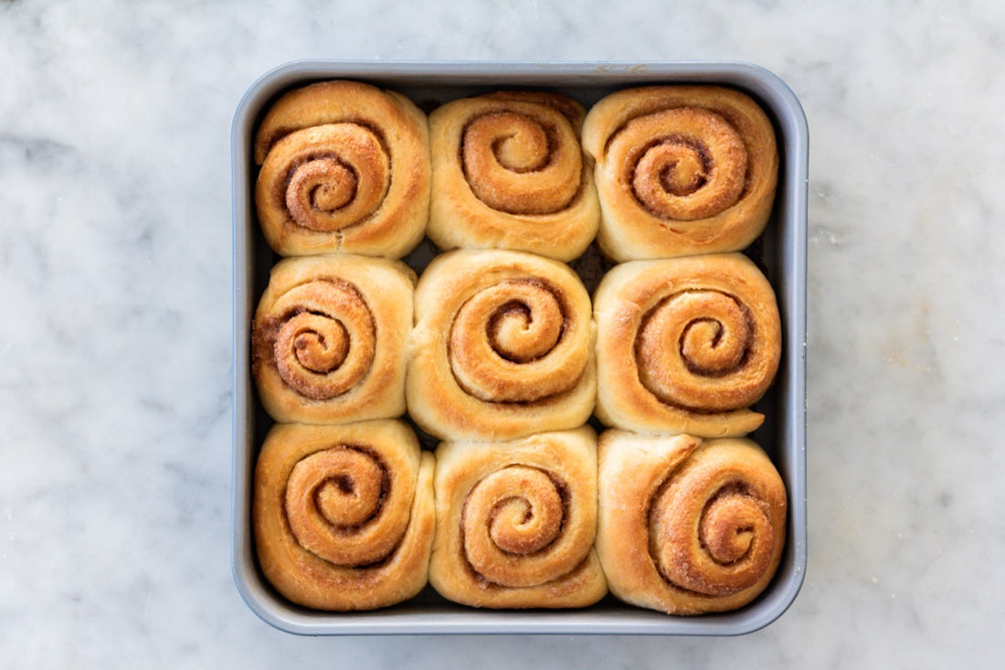 nine freshly baked cinnamon rolls in square pan