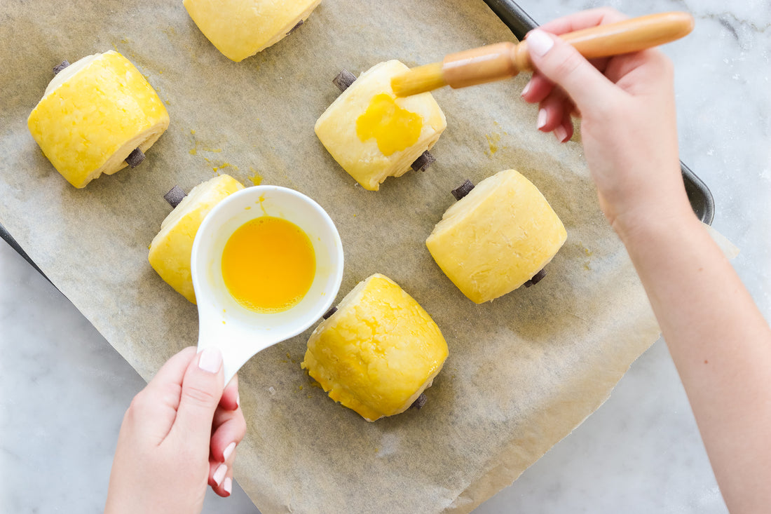 five baked pain au chocolat on wire cooling rack