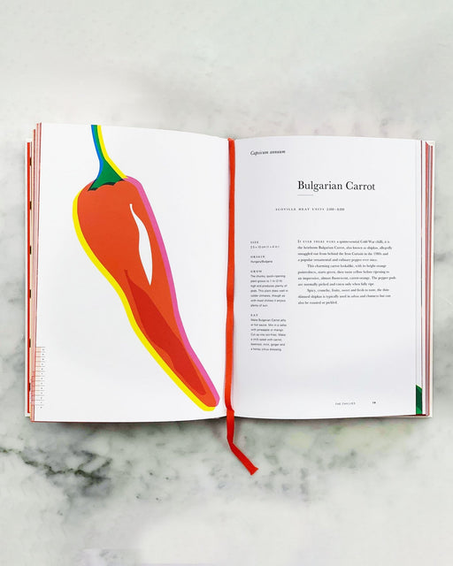 An Anarchy of Chillies book by Caz Hildebrand opened to a page on Bulgarian Carrots, laying on marble.