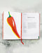 An Anarchy of Chillies book by Caz Hildebrand opened to a page on Bulgarian Carrots, laying on marble.