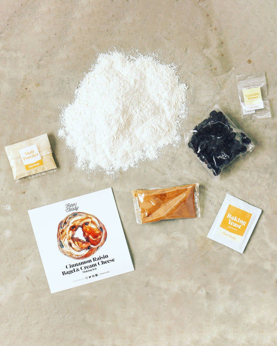 Cinnamon Raisin Bagel and Cream Cheese Making Kit contents laid out on concrete